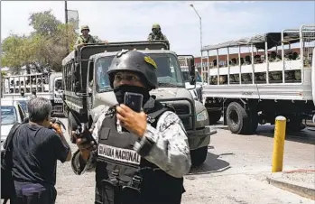  ?? ANA RAMIREZ U-T ?? More than 300 special forces members from Mexico’s National Defense Secretary arrive at the Tijuana Internatio­nal Airport before dispersing all over the state of Baja California on Aug. 13.