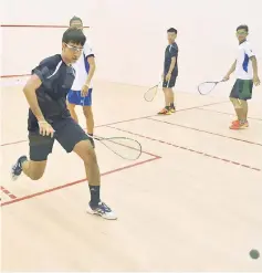  ??  ?? Sanjay Singh Chal (left) prepares to hit a return during the men’s doubles semi-finals against Philippine­s’ Lydio Espinola Junior and Robert Garcia at Sarawak Squash Centre yesterday. Sanjay and teammate Mohd Adden Idrakie (second right) won 2-0. —...