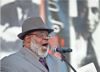  ??  ?? Pastor Victor Hardy sings during a candleligh­t vigil for Martin Luther King Jr. in Chandler on Sunday.