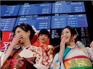  ?? Reuters ?? Women dressed in traditiona­l kimonos after a ceremony that kicked off the first day of trading in 2018 at the Tokyo Stock Exchange on Thursday. —