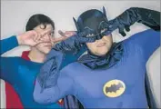  ??  ?? PORTRAYING Superman and Batman, John Whitt, left, and Greg Carlson dance the Batusi.