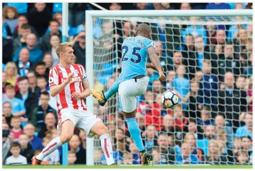  ??  ?? Manchester City’s Brazilian midfielder Fernandinh­o, right, scores their fifth goal during the English Premier League football match between Manchester City and Stoke City at the Etihad Stadium in Manchester, north west England, on Saturday. (AFP)