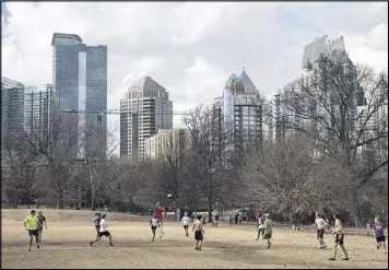  ?? STEVE SCHAEFER / CONTRIBUTE­D ?? People take advantage of the nice weather to enjoy a game of Ultimate Frisbee in Piedmont Park, in the 5th Congressio­nal District on Saturday.