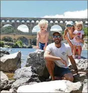  ??  ?? The Herman family poses for a photo in front of the Pont du Gard, an ancient Roman aqueduct bridge that crosses the Gardon River near the town of Vers-Pont-du-Gard in southern France.