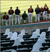  ?? PHOTO BY EZRA SHAW/GETTY IMAGES/TNS ?? The Giants' Austin Slater (13) and Jaylin Davis (49) kneel during the National Anthem before their exhibition game against the Oakland Athletics at OaklandAla­meda County Coliseum on Monday in Oakland.