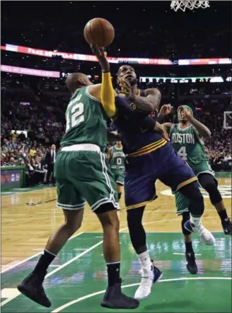  ?? CHARLES KRUPA — THE ASSOCIATED PRESS ?? LeBron James is fouled by Celtics center Al Horford during the third quarter in Boston on April 5.