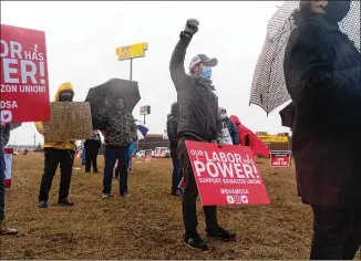  ?? Retail, Wholesale and Department Store PHOTOS BY ELIJAH NOUVELAGE/BLOOMBERG ?? Workers and activists carry signs at a rally sponsored by the Union on Feb. 6 in Bessemer, Ala. Only about 50 people attended.