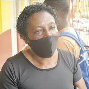  ?? (Photo: Gregory Bennett) ?? Marcia Denton, speaking to the Jamaica Observer at Holmwood Technical High School in Manchester on Tuesday, says she is uncertain how her son will engage in online classes next week.