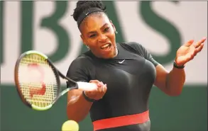  ?? Clive Brunskill / Getty Images ?? Serena Williams plays a forehand in her match against Julia Georges at the French Open on Saturday.