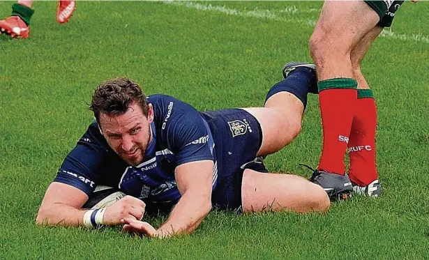  ??  ?? ●● Matt O’Regan dives in for a try during Macclesfie­ld’s victory against Sandbach in the Cheshire Cup