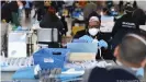  ??  ?? PPE being organised for healthcare workers at a distributi­on centre in New York.