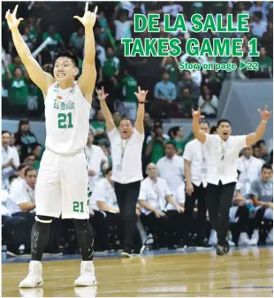  ??  ?? 1-0, DLSU — De La Salle’s Jeron Teng celebrates after scoring a go-ahead basket in the home-stretch of Game 1 of the UAAP Finals against archrival Ateneo de Manila University at the Mall of Asia Arena in Pasay City yesterday. Equally jubilant are La...