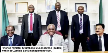  ?? ?? Finance minister Situmbeko Musokotwan­e (middle) with Indo Zambia Bank management team.