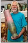  ?? (Arkansas Democrat-Gazette/ Cary Jenkins) ?? Kimbo Dryden with one of the large vases he has made for Dryden Pottery in Hot Springs.