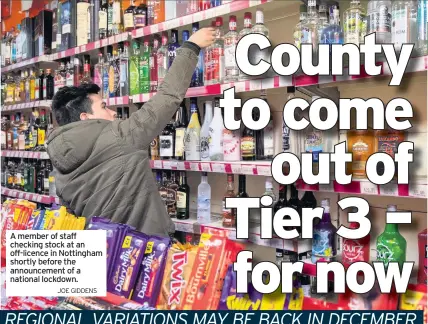  ?? JOE GIDDENS ?? A member of staff checking stock at an off-licence in Nottingham shortly before the announceme­nt of a national lockdown.