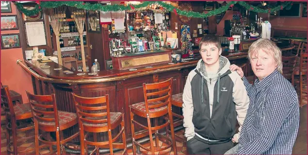  ??  ?? Proprietor Miike Leane with his son Michael, of Kirby’s Bar and Restaurant, Ballyheigu­e. Michael became the youngest publican in Ireland when he took over in 1986.