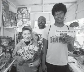  ?? STEVE MARCUS ?? Bonanza High School football coach Dion Lee poses Monday with incoming freshman Noah Nason, 13, and junior Dante Jenkins, 16, in at the team’s fireworks booth. Fireworks sale and coupon cards are part of Lee’s efforts to raise $100,000 for the football...