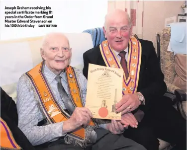  ?? DAVE TETTARD ?? Joseph Graham receiving his special certificat­e marking 81 years in the Order from Grand Master Edward Stevenson on his 100th birthday