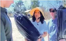  ?? ?? Melissa and Scot Congress recover the Bat Yam Temple’s Torahs, wrapped in garbage bags and stored safely in the Congress Jewelers vault during hurricane Ian. The recovery was documented by NBC Nightly News.