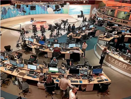  ?? AP ?? Al-Jazeera staff work at their TV station in Doha, Qatar. Dozens of journalist­s at Al Jazeera, the Qatari state-owned media company, have been targeted by advanced spyware.