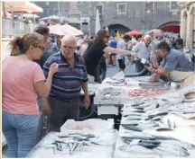  ??  ?? People shop at the fish market in Catania, eastern Sicily, Italy. — AFP