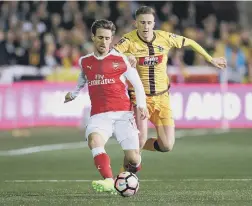  ??  ?? FLASHBACK Pompey loanee Adam May (yellow) in action for Sutton during their FA Cup fifth round tie with Arsenal on a 3G surface at Gander Green Lane in 2017