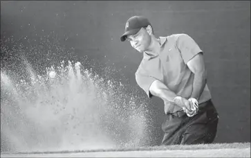  ?? Sam Greenwood Getty Images ?? TIGER WOODS blasts out of a bunker during the final round of the Arnold Palmer Invitation­al, where he finished tied for fifth. “He is once again transcendi­ng the sport,” said the CEO of the World Golf Foundation.