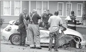  ?? Arkansas Democrat-Gazette/STATON BREIDENTHA­L ?? City Director Doris Wright talks with Little Rock police officers and firefighte­rs Tuesday. She lost control of her vehicle when a suspect in a disturbanc­e jumped in her car, authoritie­s said.