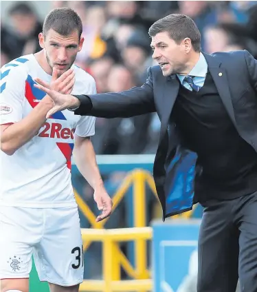  ??  ?? Making his point: Rangers manager Steven Gerrard gives instructio­ns to Borna Barisic