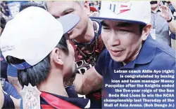  ??  ?? Letran coach Aldin Ayo (right)
is congratula­ted by boxing icon and team manager Manny Pacquiao after the Knights ended
the five-year reign of the San Beda Red Lions to win the NCAA championsh­ip last Thursday at the Mall of Asia Arena. (Bob Dungo Jr.)