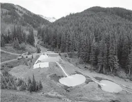  ?? BRENNAN LINSLEY/AP 2015 ?? Wastewater flows through retention ponds built to contain and filter out heavy metals and chemicals from the Gold King Mine in Silverton, Colorado.