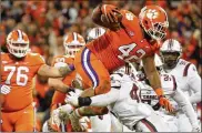  ?? GETTY IMAGES ?? Clemson defensive lineman Christian Wilkins shows his ability on the team’s goal-line offense by jumping over South Carolina’s Sherrod Greene for a TD.