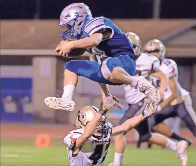  ?? Adam Dortch, File ?? Gordon Central’s Brison McGinnis leaps over a Pepperell defender during a recent game in this file photo.