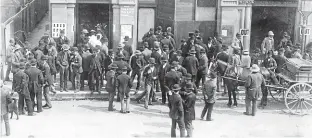  ?? PRESS ARCHIVES ?? Three anonymous women are photograph­ed entering Christchur­ch’s Tuam Street Hall, through a predominan­tly male crowd, to cast their votes for the first time.