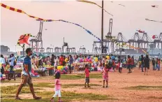  ?? Bloomberg ?? Visitors at a beach with the Port of Colombo in the
■ background. The government has only enough dollars to cover less than 2 months of imports.