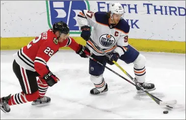  ?? NAM Y. HUH / ASSOCIATED PRESS ?? Edmonton Oilers center Connor McDavid (right), shown vying for the puck with Chicago Blackhawks’ Ryan Carpenter in March, gets just his second taste of the playoffs in his fifth season.