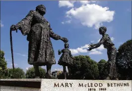  ?? RICK MCKAY / COX NEWSPAPERS ?? A statue of Mary McLeod Bethune with two small children sits in Lincoln Park in Washington, D.C. Bethune, who founded Bethune-Cookman University in Daytona Beach, may soon be honored by Florida in Statuary Hall.