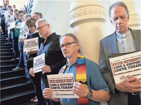  ?? JAY JANNER, AUSTIN AMERICAN-STATESMAN, VIA AP ?? Dozens of members of the clergy pray in opposition to bills they consider anti-LGBT at the Capitol in Austin on May 3.