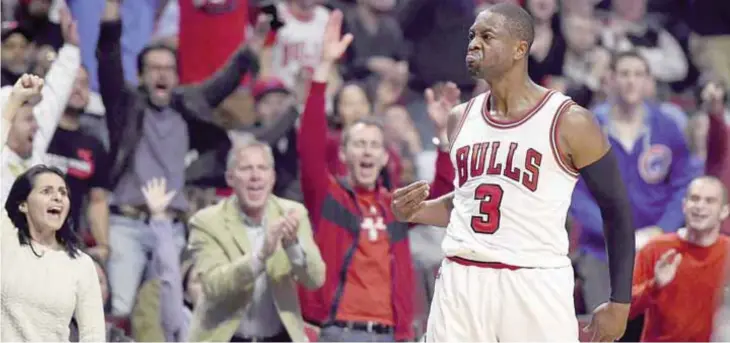  ??  ?? CHICAGO: Dwyane Wade #3 of the Chicago Bulls reacts to a three point shot late in the fourth quarter against the Boston Celtics at the United Center. —AFP