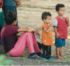  ?? ERIC GAY/AP ?? Migrants wait to be processed by Customs and Border Protection personnel on Friday at Eagle Pass, Texas, after illegally crossing the Rio Grande from Mexico.