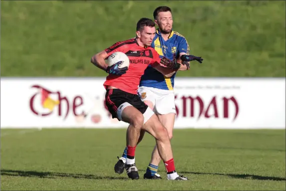  ??  ?? Mitchelsto­wn’s Shane Beston tries to hold off Ballydesmo­nd’s Jerry Healy as he heads for goal during last Saturday’s drawn County Intermedia­te Football Championsh­ip game in Mallow Photo by Eric Barry