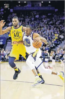  ?? EZRA SHAW/GETTY IMAGES ?? The Warriors’ Andre Iguodala drives on the Pacers’ Glenn Robinson III at ORACLE Arena on March 27 in Oakland, Calif.