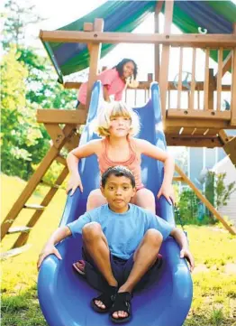  ?? GETTY IMAGES ?? A backyard play set should have enough space so kids can run around it and slide and swing without obstructio­n.