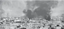  ??  ?? Smoke rises from a neighbourh­ood in west Mosul, during an offensive by the Iraqi forces to retake the city from Islamic State (IS) group fighters on March 24, 2017