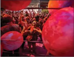  ?? (AP/Anupam Nath) ?? People celebrate Holi on Wednesday on a street in Guwahati.