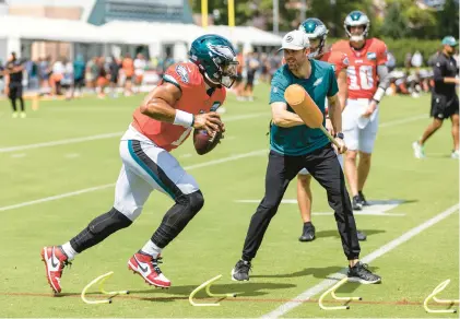  ?? TYGER WILLIAMS/THE PHILADELPH­IA INQUIRER ?? Eagles quarterbac­k Jalen Hurts, wearing Nike Air Jordan cleats, runs a drill Tuesday during a joint practice with the Browns at the Novacare Complex in Philadelph­ia.
