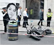  ??  ?? A bike on its side outside Watches of Switzerlan­d on Regent St, London, after raiders armed with knives and hammers targeted the store last week