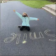  ??  ?? Carly Thompson, 9, Birdsboro Girl Scout Troop 1080, chalks “Smile” on the walkway during the “Chalk the Vote” activity on Nov. 2.