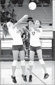  ?? Photo by Mike Eckels ?? The Lady Bulldogs’ Destiny Meija (16) and Leticia Fuentes (17) set up for a bump during the third set of the Decatur-Elkins volleyball match at Peterson Gym in Decatur on Oct. 12. Fuentes intercepte­d the ball, sending it deep into Lady Elks territory...