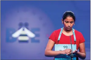  ?? Special to the Democrat-Gazette/PETE MAROVICH ?? Pavani Chittemset­ty, 12, of Bentonvill­e, spells her first word onstage Tuesday as she participat­es in the second round of the Scripps National Spelling Bee. Pavani was one of three children from Arkansas who will participat­e in today’s third round.